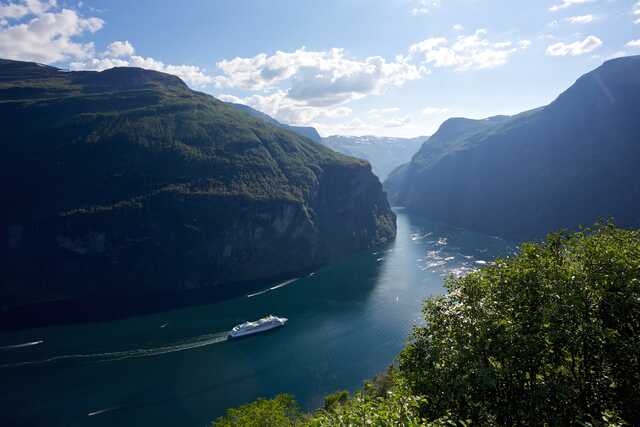 Cruise ship sailing through Geirangerfjord Norway