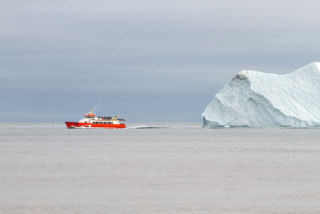 Tour Boat Passing Arctic Iceberg