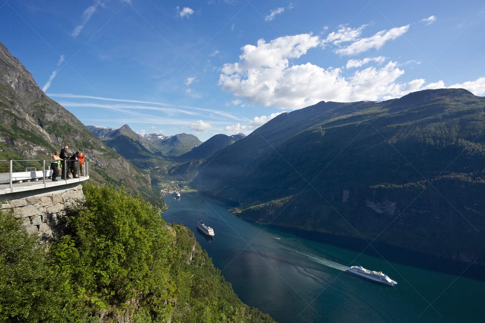 Tourists overlooking Geirangerfjord with cruise ships Norway