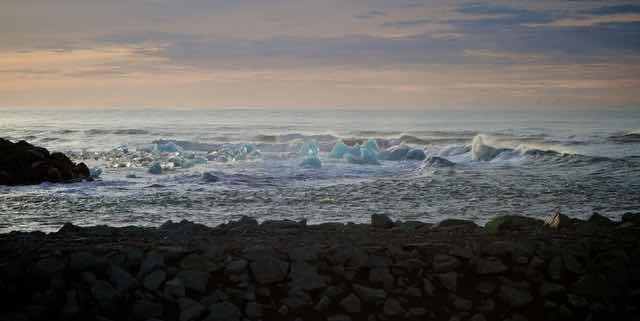 Icebergs Floating Near Rocky Shore at Diamond Beach Iceland