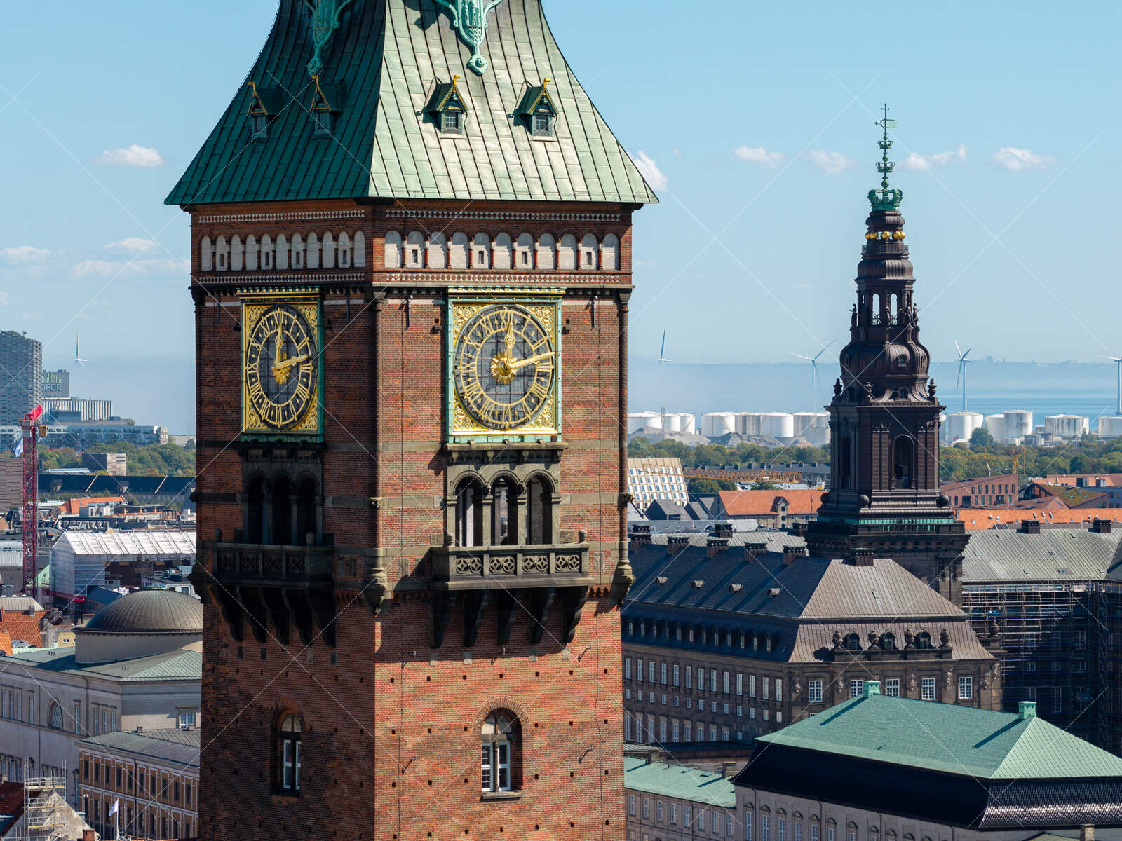 Historic clock tower and spire in Copenhagen cityscape