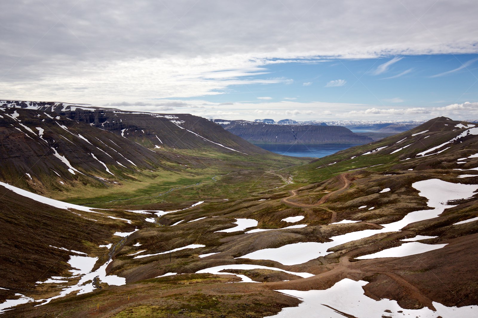 Westfjords valley with snow patches in Ísafjarðarbær Iceland