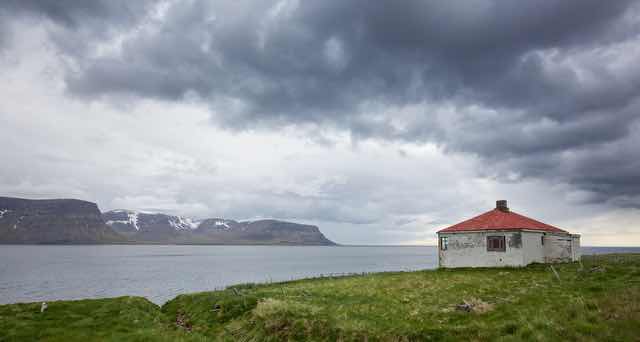 Abandoned house by fjord in Ísafjarðarbær Iceland
