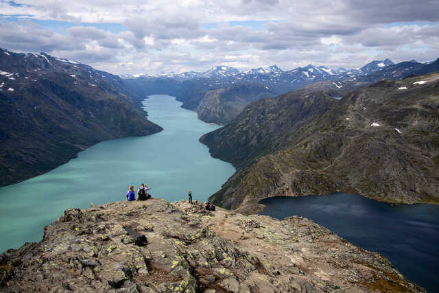 Hikers overlooking Lake Gjende and Besseggen Ridge in Norway