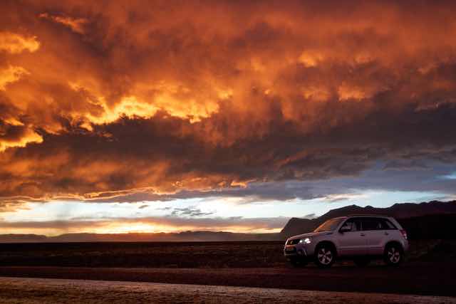 4x4 SUV at dramatic sunset in Icelandic wilderness