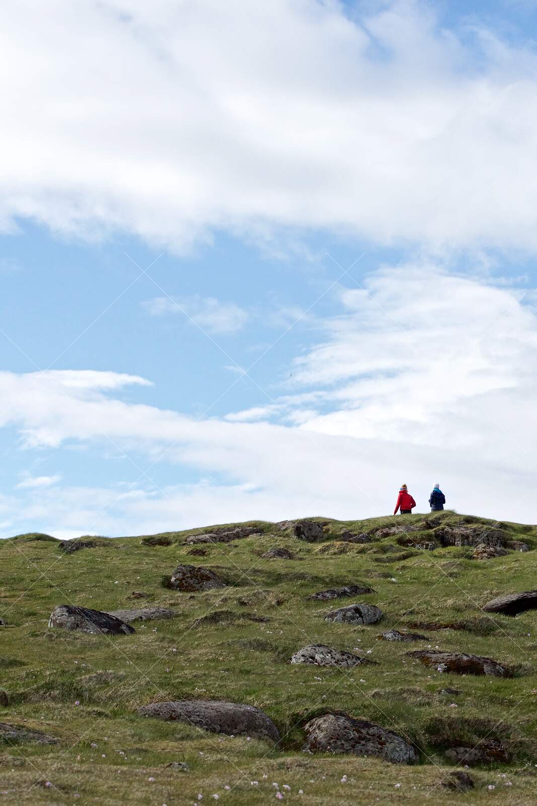 Two People Walking on Rocky Hill at Látrabjarg, Iceland