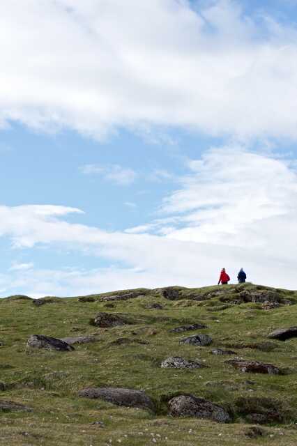 Two People Walking on Rocky Hill at Látrabjarg, Iceland