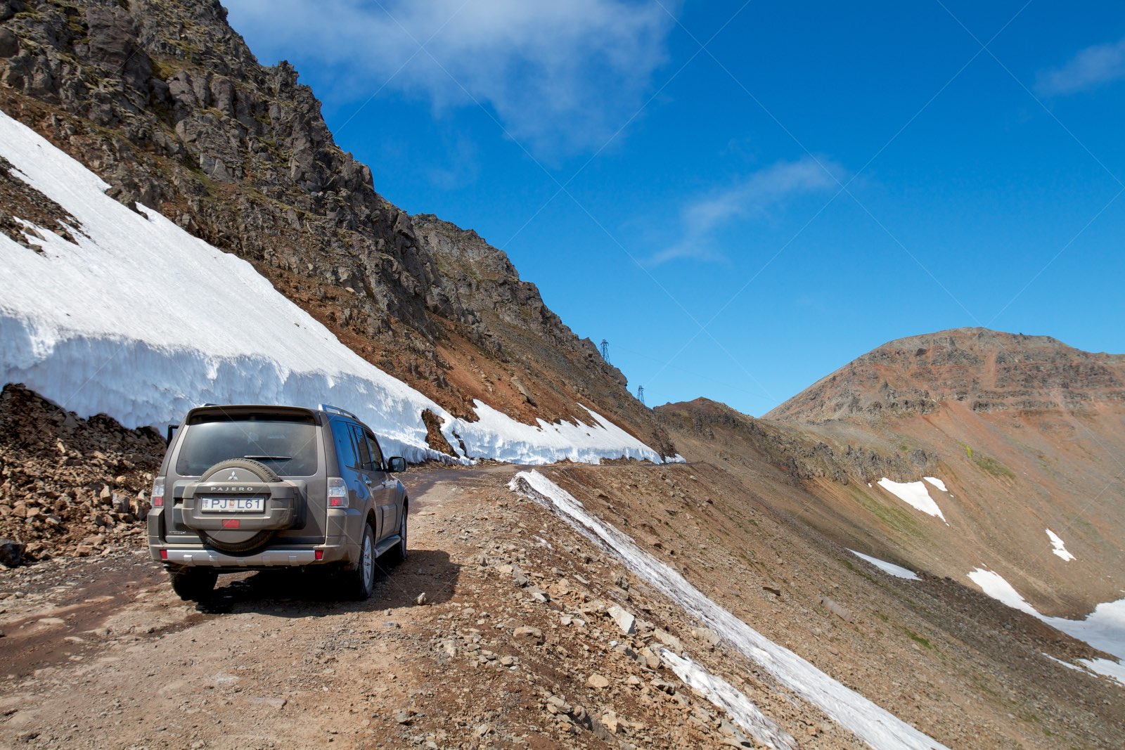 SUV driving on Skardsvegur mountain road in Fjallabyggð Iceland