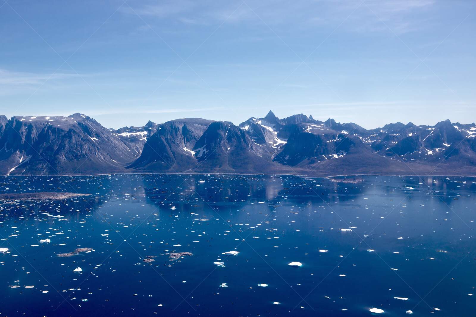Arctic fjord with floating ice and rugged mountains
