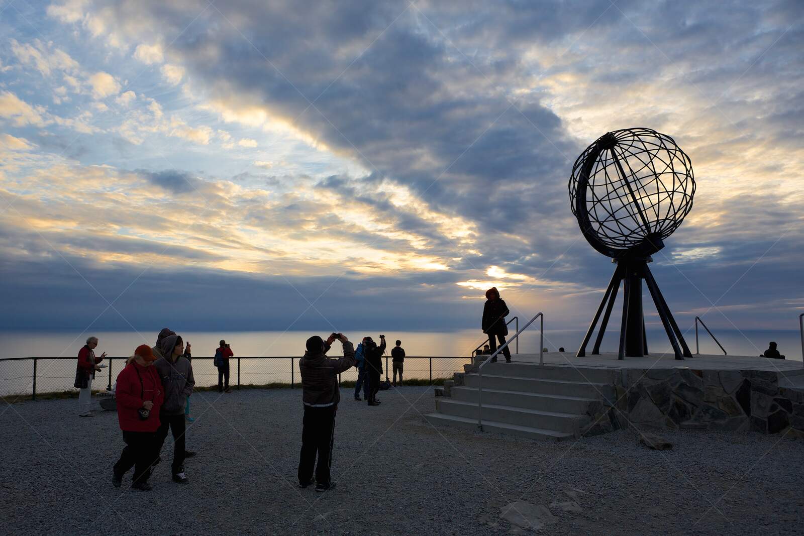 Tourists at the North Cape Globe Monument in Norway