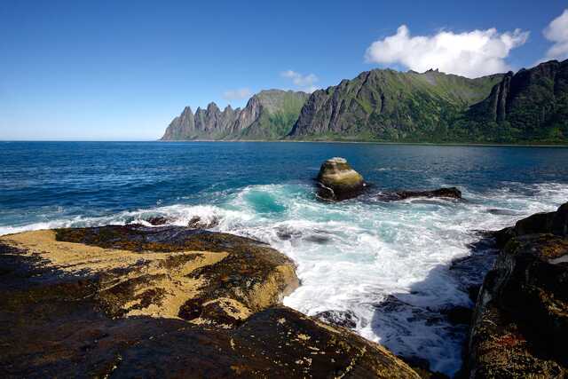 Rocky coastline and rugged peaks in Senja Norway
