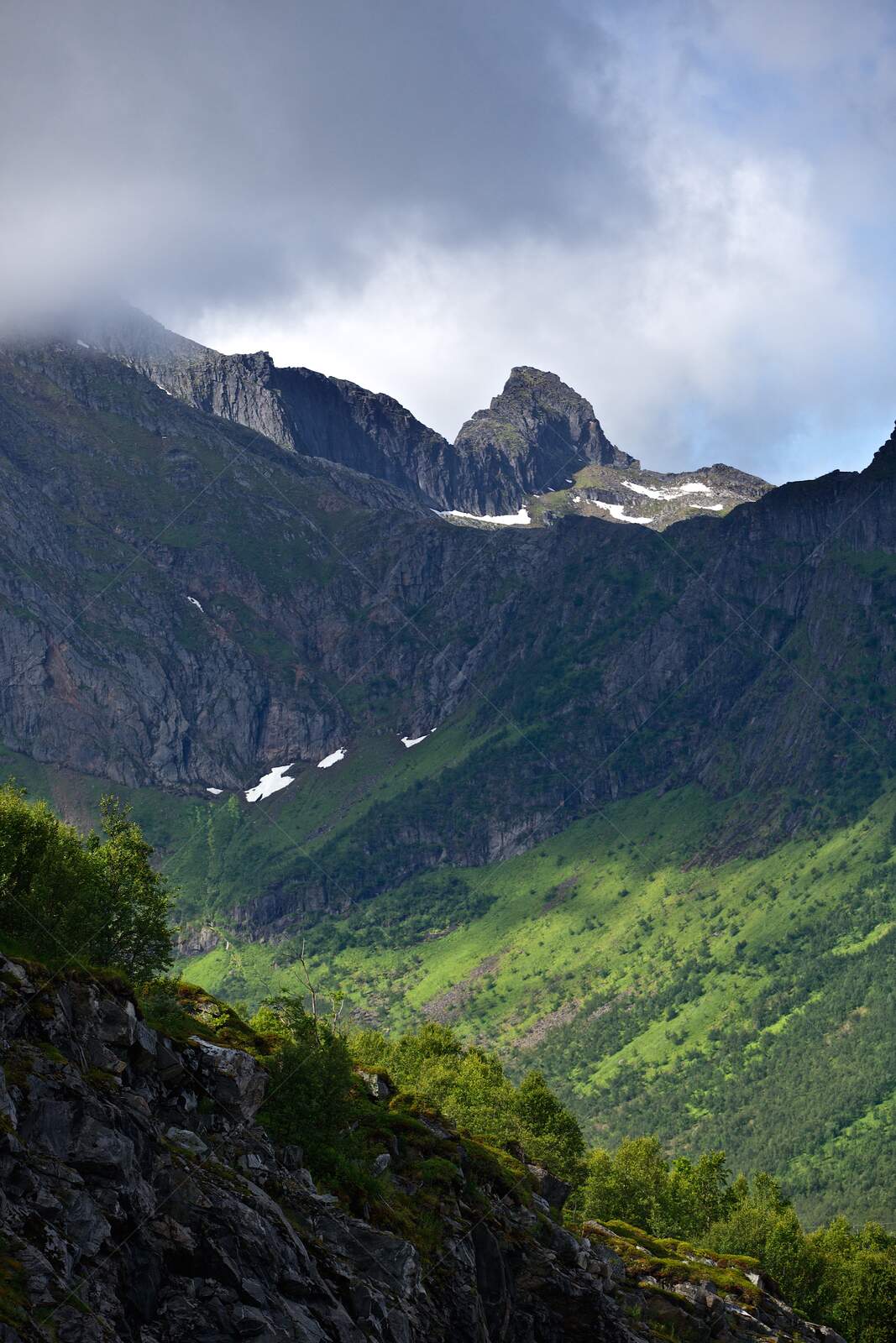 Mountain peaks and green slopes in Senja Norway