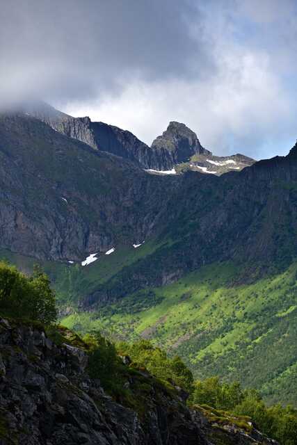 Mountain peaks and green slopes in Senja Norway