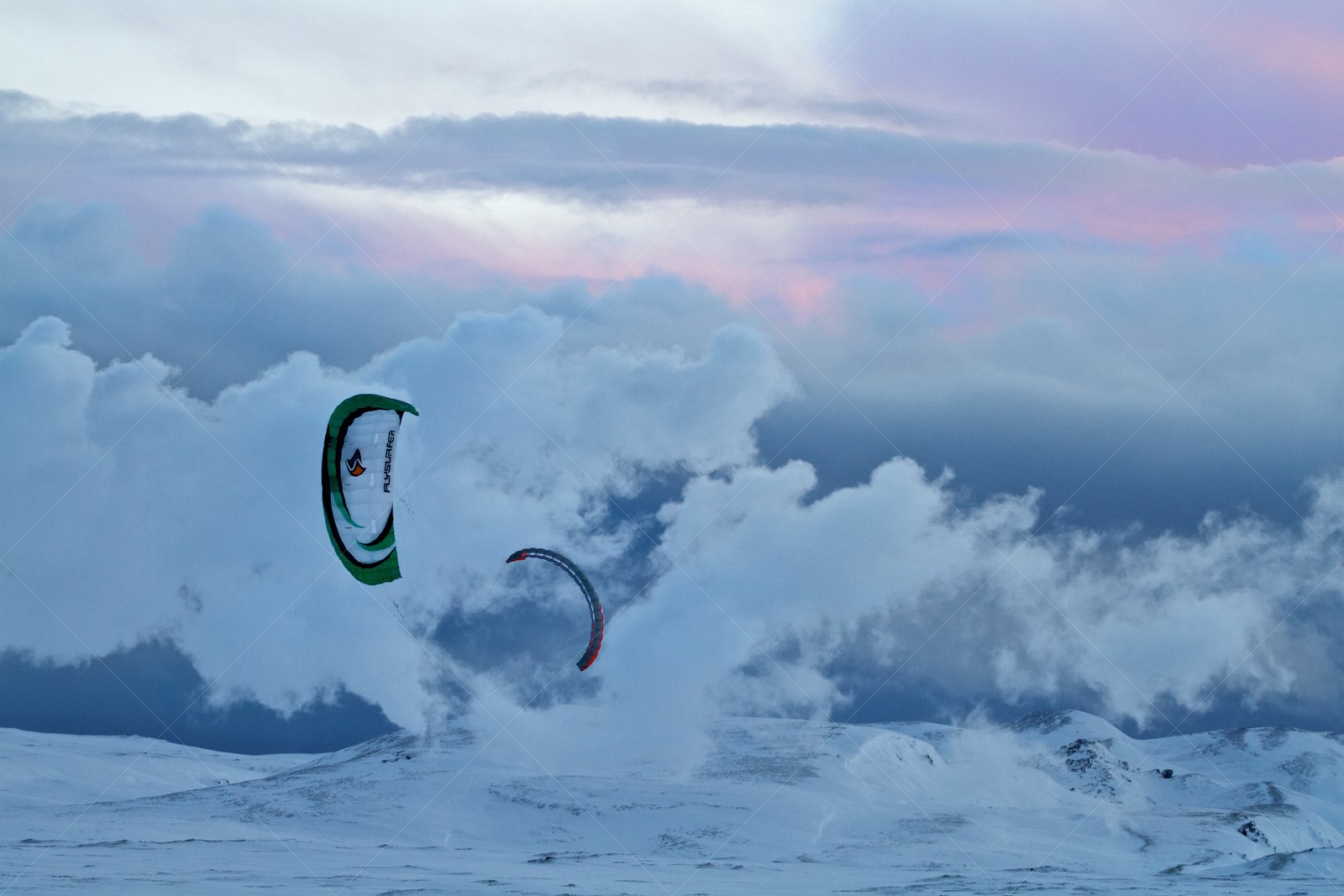 Snowkiting on a snowy Icelandic mountain landscape