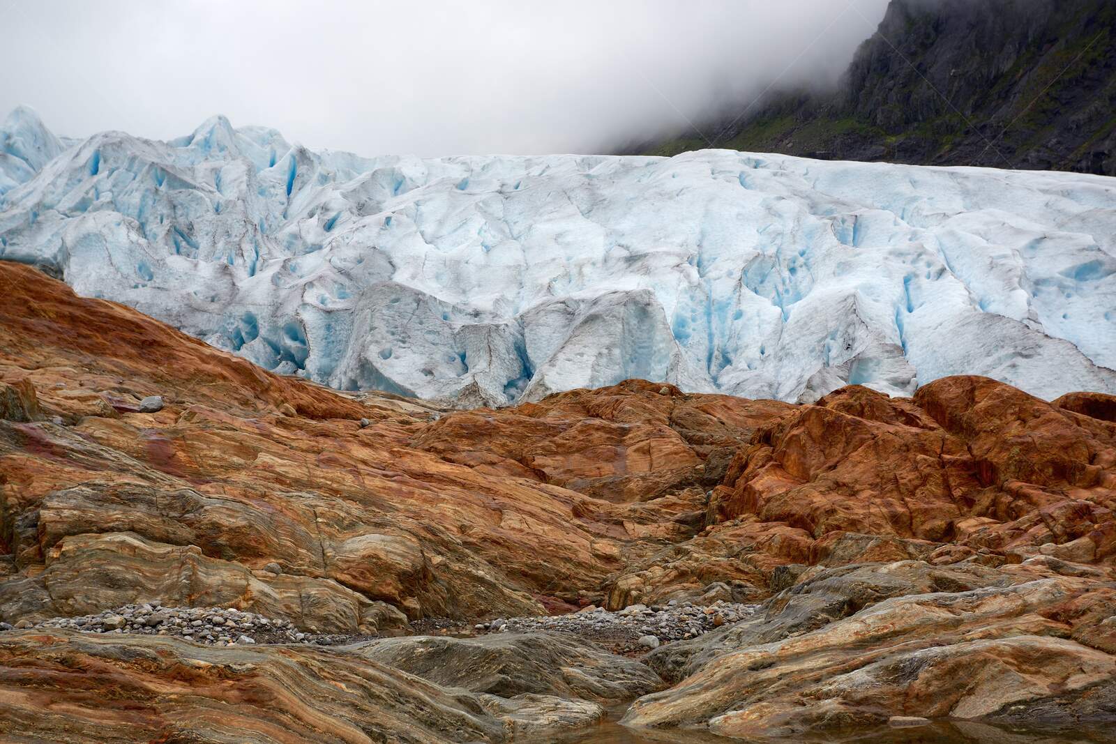 Svartisen Glacier meeting rocky terrain in Meløy Norway